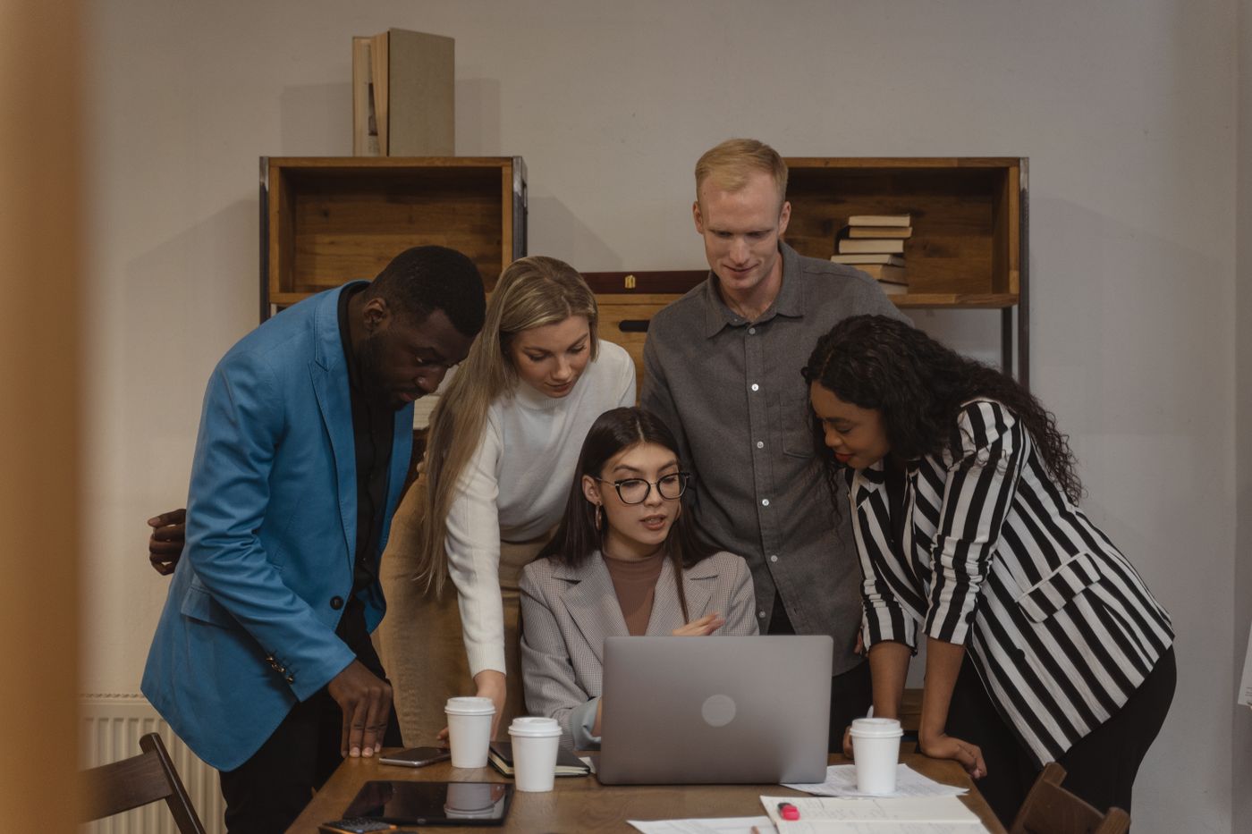 Small business team planning website improvements around a laptop